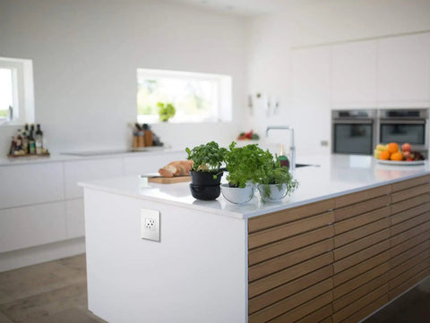 Modern kitchen island with Adorne 15 Amp Tamper Resistant Outlet With Matching Wall Plate White Finish 4 Pack Contractor Pack visible