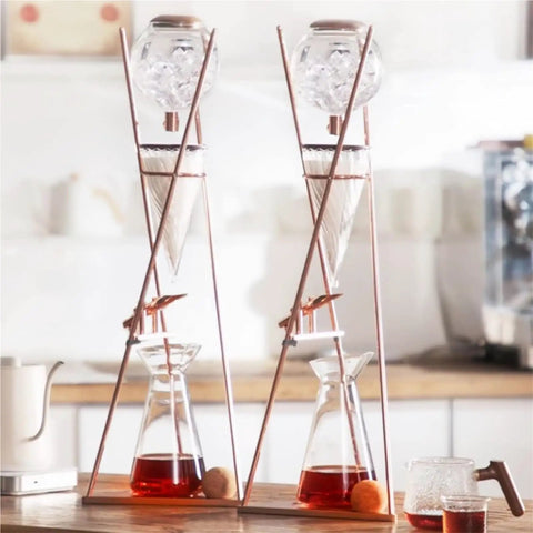 Top Shelf Cold Brew Drip Tower And Ice Drip Coffee Maker With 800Ml Borosilicate Glass Carafe, steel stand, iced coffee in glass.