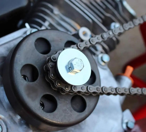 Badass Go Kart Clutch Bolt Kit Featuring Precision Metric M8 And Five Sixteenths Inch Drive Fasteners Paired With Rugged Lock Washers For Rock Solid Three Quarter Shaft Engines on a quad bike's engine.