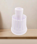 Front view of white plastic onion blossom maker cutter on a wooden kitchen counter