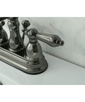 Close-up of a 4 Inch Centerset Lavatory Faucet With Brass Pop Up Drain in Black Stainless Steel Deck Mount 3 Hole Installation