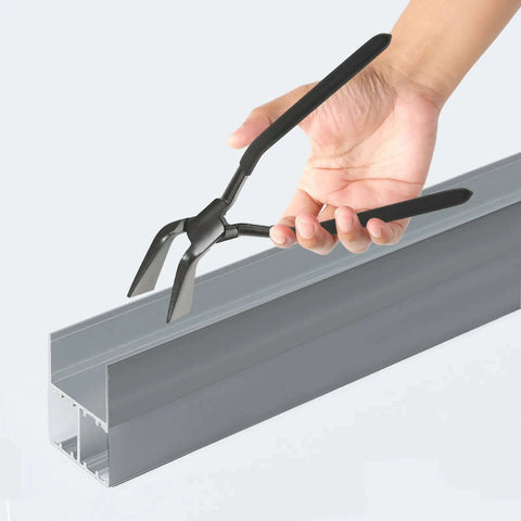 Hand holding Pro Grade Bending Pliers from Three Piece Hand Seamer Set For Sheet Metal, showing ergonomic handles and heavy-duty use.