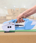Heavy Duty Electric Strapping Tool Portable Handheld Pallet Baler Cuts And Heat Seals PP PET Bands No Buckles Needed in use with cardboard.