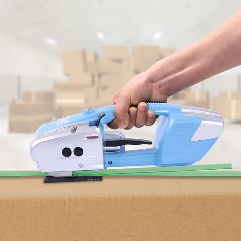 Heavy Duty Electric Strapping Tool Portable Handheld Pallet Baler Cuts And Heat Seals PP PET Bands No Buckles Needed in use with cardboard.