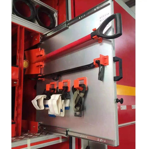 Fire truck equipment compartment with tools and straps organized inside, showing practical tool storage solutions.