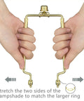 Hands adjusting Adjustable Lamp Shade Harp Holder Fits Seven To Ten Inch Shades Three Eighths Inch Saddle Polished Brass