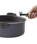 Hand holding Digital Instant Read Kitchen Thermometer With LCD Display And Stainless Steel Probe Recalibratable in pot