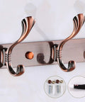 Heavy Duty Stainless Steel Wall Coat Rack With Five Sturdy Hooks For Coats Hats Robes And Towels close-up of bronze hooks on wall.