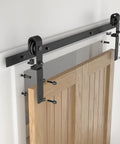 Bi-Fold Sliding Barn Door Hardware Kit 48 Inch For Two 22 Inch Doors Heavy Duty Track System Black Finish installation close-up
