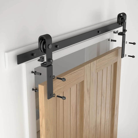 52 Inch Bi Folding Sliding Barn Door Hardware Kit Heavy Duty Track Roller System For Up To 24 Inch By 2 Doors, installed over wooden doors.