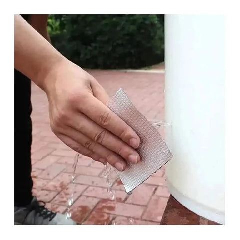 Person using Waterproof Self Adhesive Butyl Tape for Leak Repair on outdoor water container, 5cm by 5m, quick fix weatherproof seal.