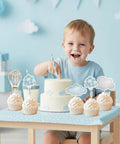 Adventure Awaits Hot Air Balloon Cupcake Toppers 36 Piece Set Blue Clouds Party Picks with child eating cake at table