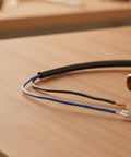 Premium Pressure Washer Switch Assembly Replacement With Pre-Stripped Wires And Durable Brass Threaded Connector In Compact Rectangular Housing close-up of black and blue wires.