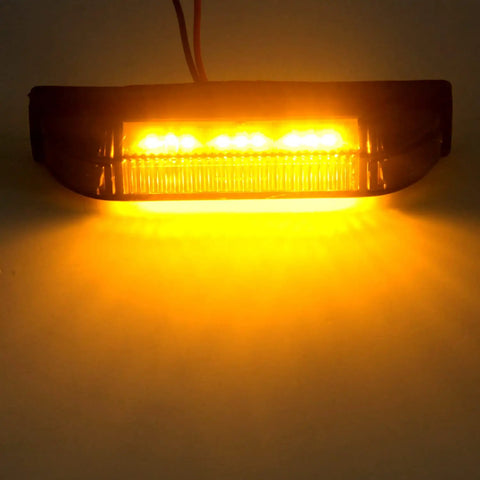 Illuminated Smoked Amber 4 Inch LED Front Grille Marker Light Kit, Nine LEDs Per Light, emitting amber light in a dark setting.