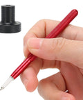 Hand using Watch Oiler Pen Pro Tool With Precision Oil Pin For Smooth Gear Movement, Includes Red Alloy Pen And Black Base close-up