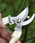 Close-up of stainless steel No Fuss Ergonomic Garden Pruning Shears With Bypass Blade cutting a twig, ergonomic grip visible