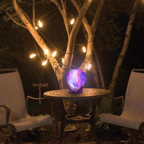 Moon Lamp Galaxy Night Light 5.9 Inch With 16 Colors LED 3D Moon Surface on a patio table at night