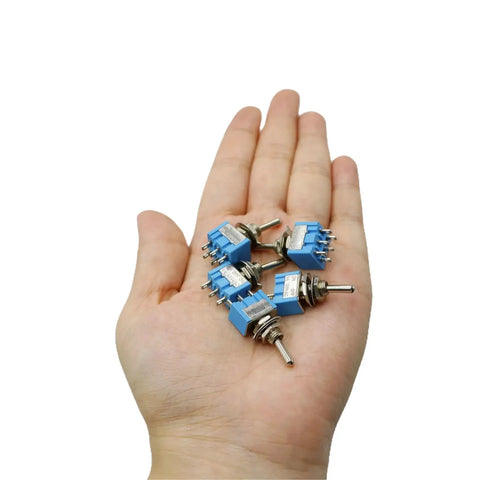Hand holding Assorted Mini Toggle Switch Kit 2 Pin 3 Pin 6 Pin SPST SPDT Latching Micro Rocker On Off On 6A 125V