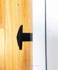 Side view of Western Cowboy Horseshoe Hand Painted Resin Cabinet Knob installed on a wooden drawer showcasing rustic design.