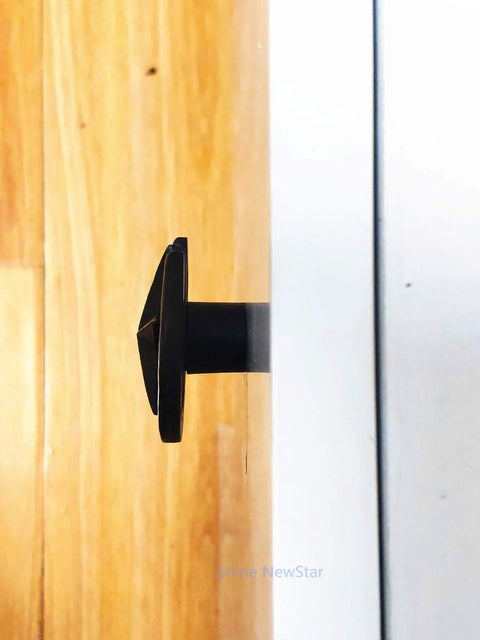 Side view of Western Cowboy Horseshoe Hand Painted Resin Cabinet Knob installed on a wooden drawer showcasing rustic design.