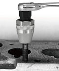 Gritty Bolt Breaker And Stud Extractor Kit For 3/8 Inch Drive loosening a rusted stud using a ratchet on machinery surface