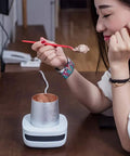 Keep Your Morning Sip Hit The Spot With This Versatile Travel Coffee Mug Warmer That Heats Or Chills Drinks Quickly Ideal For Commutes Desk Work And Home Offices, woman enjoying ice cream with compact warmer on desk.