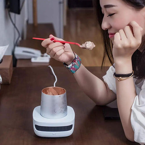 Keep Your Morning Sip Hit The Spot With This Versatile Travel Coffee Mug Warmer That Heats Or Chills Drinks Quickly Ideal For Commutes Desk Work And Home Offices, woman enjoying ice cream with compact warmer on desk.