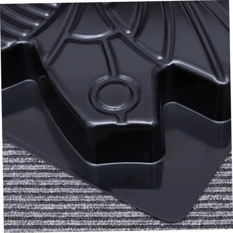 Close-up of Butterfly Shaped Paving Mold For Garden Paths And Walkways, Reusable Concrete Stepping Stone Mold, black plastic surface.