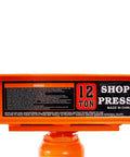Heavy Duty 12 Ton Hydraulic Shop Press With Portable H Frame showing warning label and 12 ton marking in bright orange.