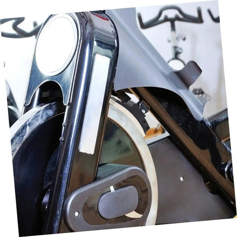 Close-up of exercise bike with Four Piece Fitness Bike Brake Pad Set for Exercise Bike Replacement Braking Pads Easy Install