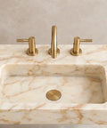 Top Shelf Hand Carved Afyon Honey Marble Bathroom Vanity Sink With Slick Countertop Setup And Durable Natural Stone Craft For Upscale Residential Or Swanky Commercial Decor, top view with faucet.