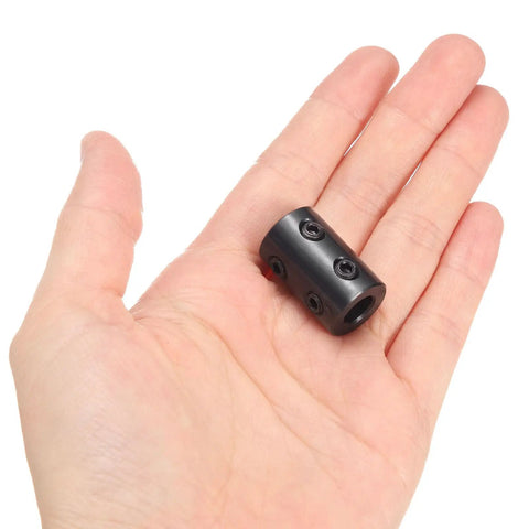 Rock-Solid Rigid Shaft Coupling 5/16 Inch Bore, 5/8 Inch OD, 1 Inch Length, Black Oxide Plated Steel With Hex Wrench For 3D Printers, Motors And Wheels, Includes Four Screws Each Piece, shown in hand