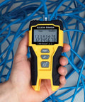 Person holding LAN Scout Jr 2 Ethernet Cable Tester For CAT5e CAT6 CAT6A RJ45 Cables With Backlit LCD wiremap display.