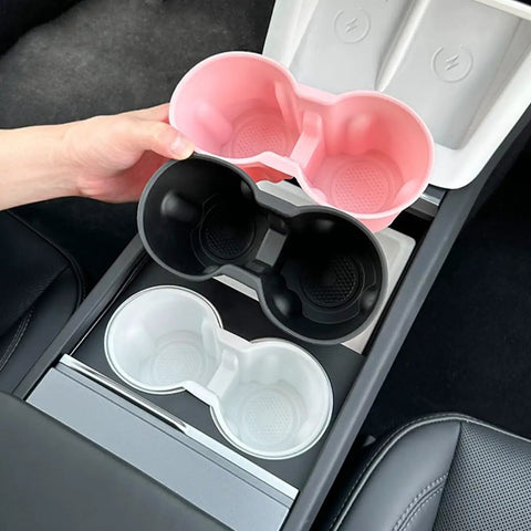 Slick Drop In Premium Soft Silicone Cup Holder Insert For Tesla Model 3 Highland 2024 And Up shown in three colors: pink, black, and white.