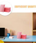 Stack of pink bubble padded mailers self seal envelopes 100 pack for jewelry and makeup supplies on a desk setup