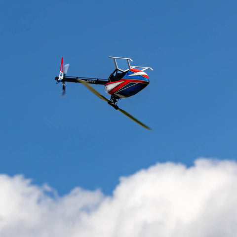 Fusion 700 Kit High Performance Super Combo with carbon 700mm rotor and 105mm tail blades flying against blue sky