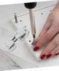 Installing concealed cabinet hinges on white furniture piece