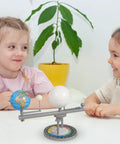 Two children engaged with the Straight Up Premium Sun Earth And Moon Orbital Model Solar System Educational Display for learning.