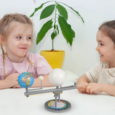 Two children engaged with the Straight Up Premium Sun Earth And Moon Orbital Model Solar System Educational Display for learning.