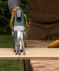 Pro Grade Heavy Duty Electric Fiber Cement Siding Cutter With Six Point Five Amp Motor cutting through board on a workbench.