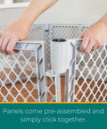 Hands assembling Six Panel Petyard Passage Dog Playpen Fence With Wall Mount Kit Easy Setup Freestanding Or Wall Mounted