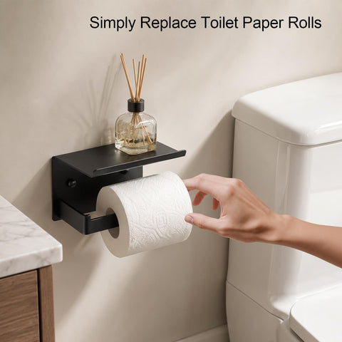 Rock Solid Matte Black Toilet Paper Holder With Storage Shelf Wall Mount For Bathrooms Fits Mega Rolls showing hand replacing toilet paper roll.