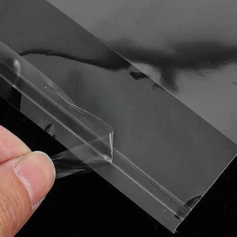 Close-up of 100 Pack No Brainer Clear BOPP Self Sealing Bags For Snacks Candy Baking with resealable opening being peeled open