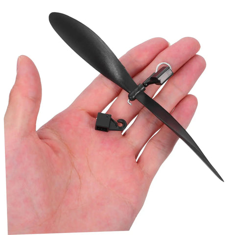 Hand holding black plastic propeller from 10 Pack RC Airplane Propeller Set With 6x4mm Hole Diameter Fold Resistant Plastic Blades