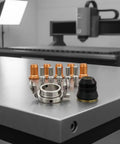 Tough As Nails 12 Piece Plasma Torch Parts Kit Featuring Copper Alignment Nozzles and Precision Parts on Metal Work Surface.
