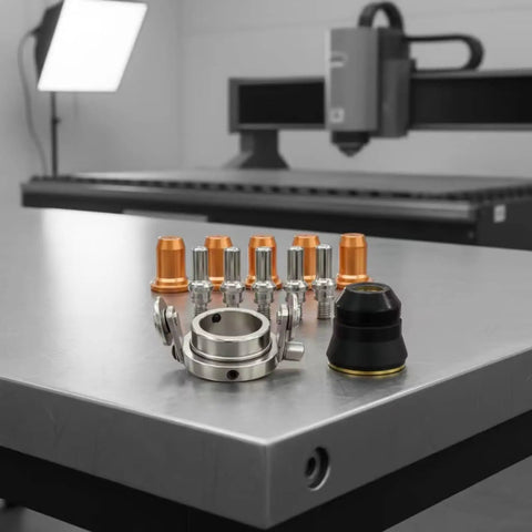 Tough As Nails 12 Piece Plasma Torch Parts Kit Featuring Copper Alignment Nozzles and Precision Parts on Metal Work Surface.