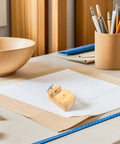 Sturdy Wooden Carving Clamp And Mini Bench Vise For Stone Seal Engraving on a crafts table with pens and paper.