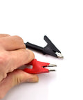 Heavy Duty Badass Alligator Clip Test Leads 14 Awg Silicone Jumper Wires 3 Feet with red and black probes in hand.