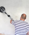 Person using Drywall Sander Kit With 710W Electric Sander, 12 Discs, 5 Speed Settings on wall for smooth finish