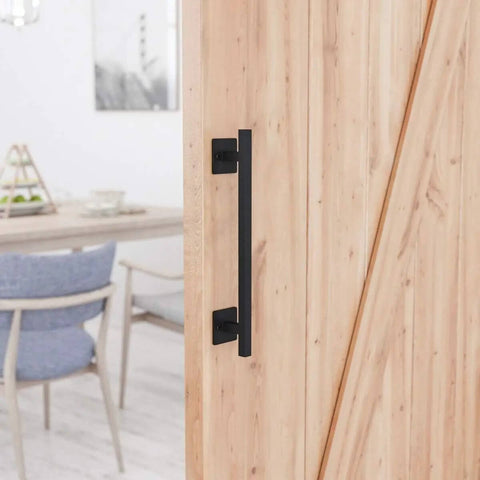 Antique Rustic Twelve And Five Eighths Inch Barn Door Handle in frosted black steel installed on wooden door